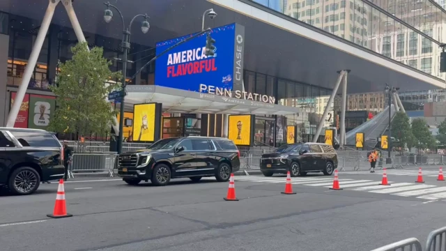 Two black SUVs driving into Madison Square Gardens entance