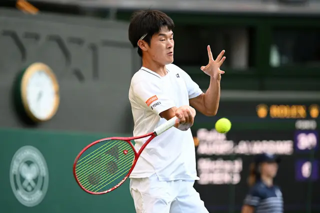 Michael Zheng of United States plays a forehand