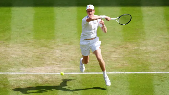 Jannik Sinner of Italy hits a forehand