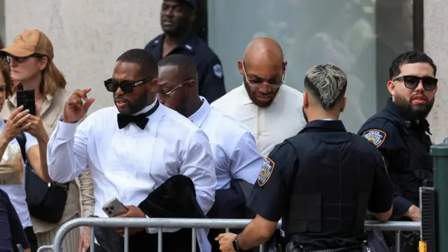 Three men in white shirts arrive at Madison Square Garden