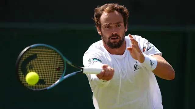 Roman Safiullin hits a forehand