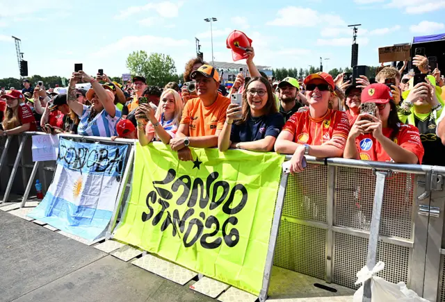 Fans with banners for Lando Norris and Franco Colapinto in the fanzone