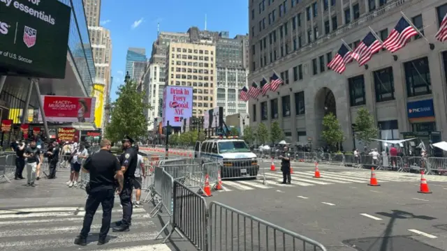 A number of barriers have been put in place on a busy street with orange cones and metal barriers