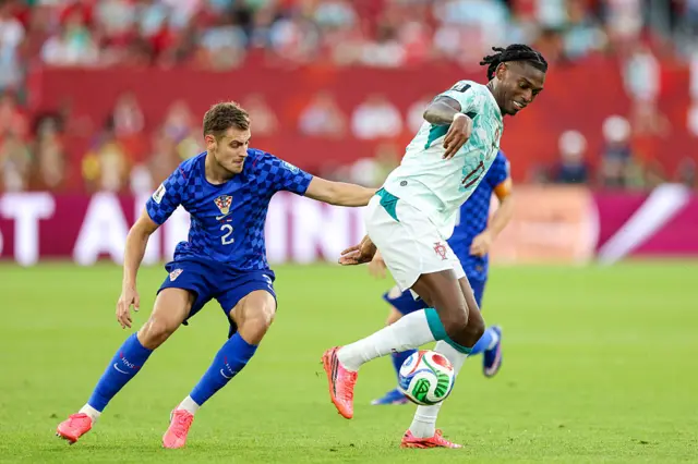 Josip Stanisic of Croatia and Rafael Leao of Portugal compete