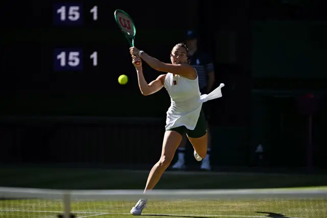 Aryna Sabalenka returns a backhand