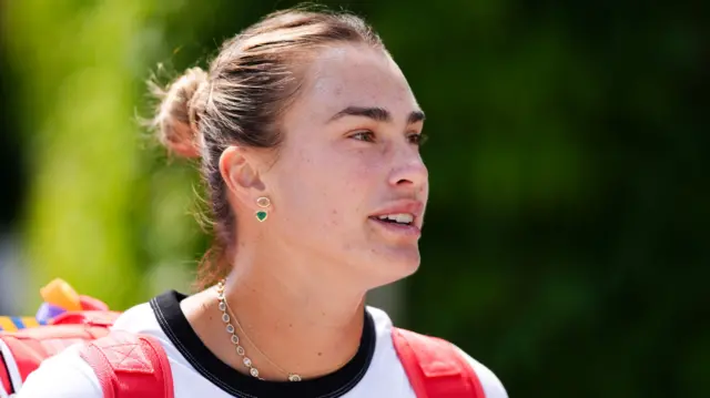 Aryna Sabalenka walks to a practice session