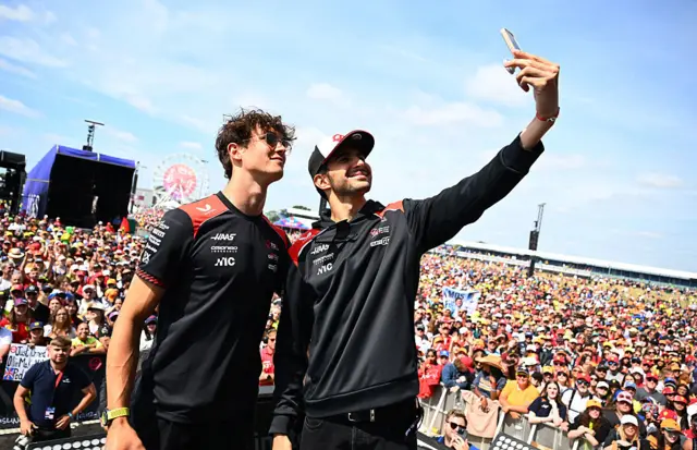 Ollie Bearman and Esteban Ocon take a picture with the fans at Silverstone