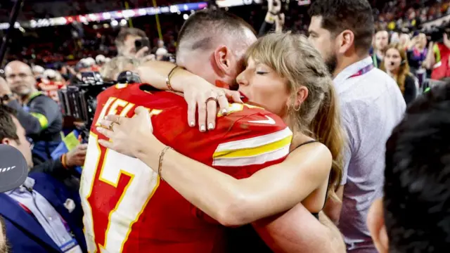 Swift and Kelce embrace at an NFL game in February 2024