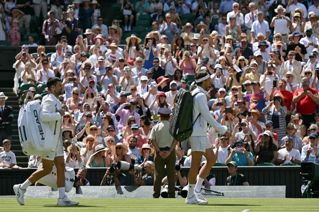 France's Arthur Rinderknech (R) and Serbia's Novak Djokovic arrive for their men's singles third round tennis match