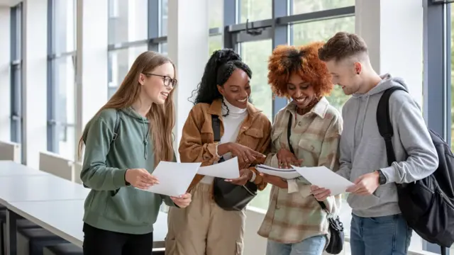 Stock image shows students looking at exam results