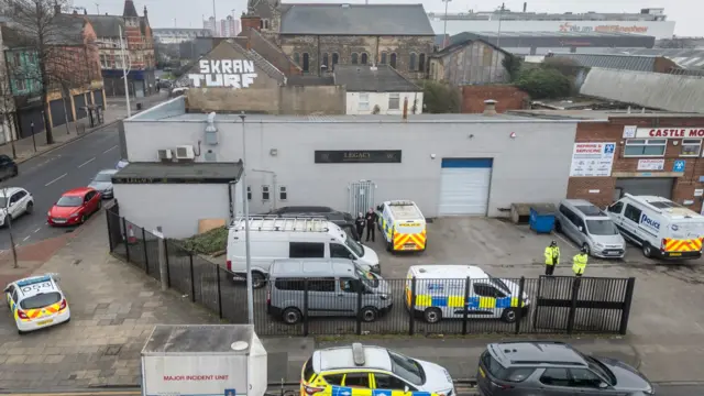 Aerial view of the Legacy funeral home in Hull a single story industrial unit number of police vehicles are parked outside
