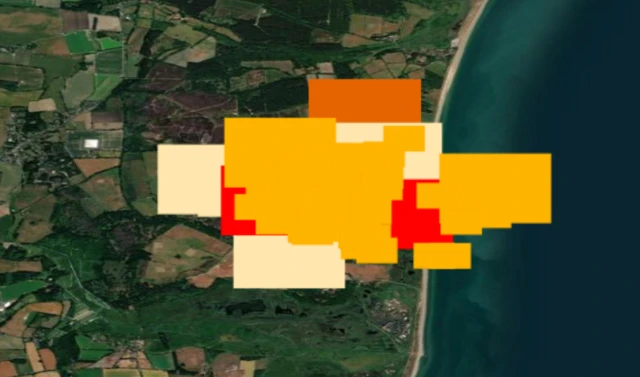 A satellite map of the Suffolk coast. Thermal anomolies are marked by red, yellow and orange rectangles. A large area is obscured by them, including over the water.