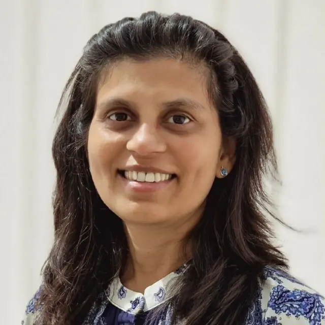 Priya's portrait, with her looking at the camera and smiling