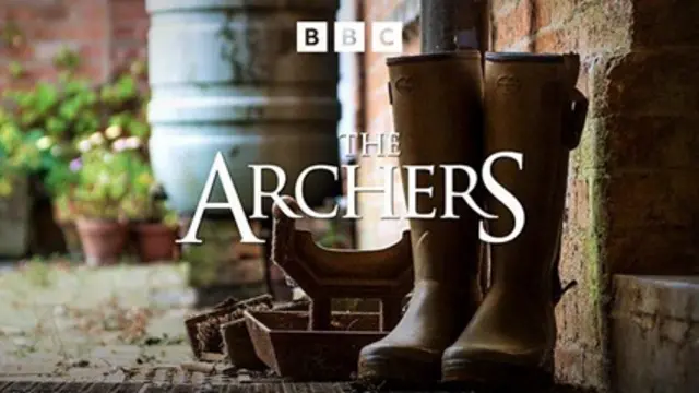 The Archers logo. It features the words 'The Archers' in white text against a background showing welly boots, a brick wall and potted plants