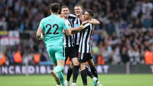 Nick Pope, Sven Botman, Dan Burn and Fabian Schaer of Newcastle United celebrate after qualifying for the UEFA Champions League following the Premier League match between Newcastle United and Leicester City at St. James Park on May 22, 2023 in Newcastle upon Tyne, England