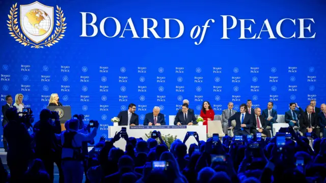 US President Donald Trump (C) holds a signing ceremony for the 'Board of Peace' charter during the 56th annual meeting of the World Economic Forum (WEF), in Davos, Switzerland, 22 January 2026