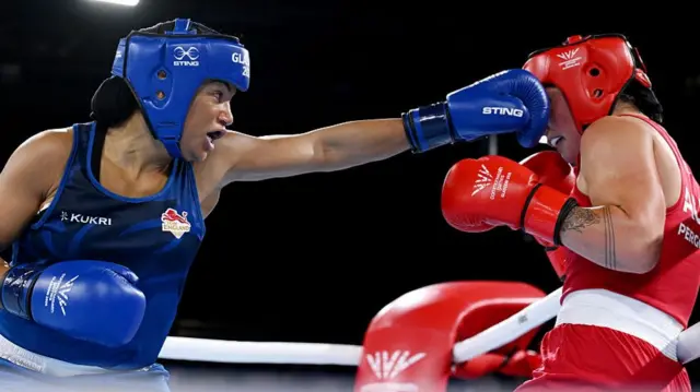 England's Chantelle Reid fights Australia's Lekeisha Pergoliti in the women's 70kg semi-finals at the Commonwealth Games in Glasgow