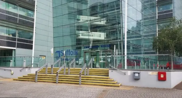An external view of Suffolk County Council's headquarters. There are steps up to the entrance and lots of windows.