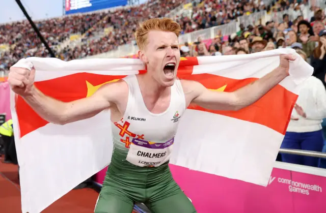 Alastair Chalmers of Team Guernsey celebrates after winning the bronze medal in the Men's 400m Hurdles Final