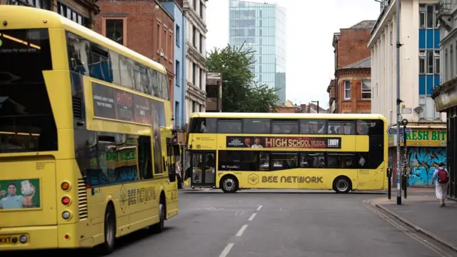 Yellow public buses in Manchester.