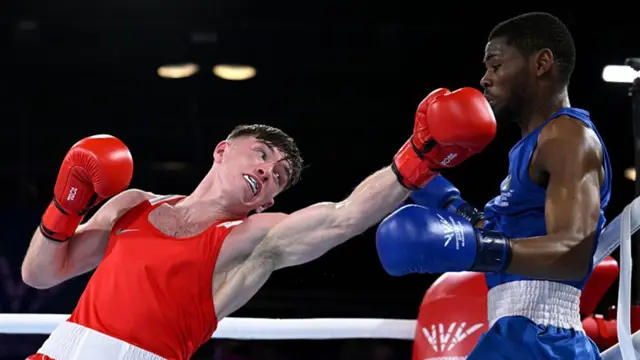 Northern Ireland's Jude Gallagher misses with punch in his Commonwealth Games semi-final against Namibia's Tryagain Morning Ndevelo
