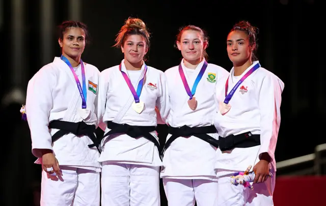 Gold medalist Acelya Toprak of Team England, Silver medalist Yamini Mourya of Team India and Bronze medalists Donne Breytenbach of Team South Africa and Lele Nairne of Team England pose for a photo during the medal ceremony for the Women's Judo -57 kg