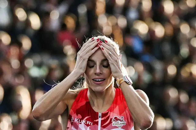 Georgia Hunter Bell holds her head in her hands