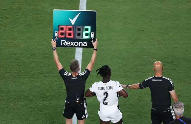 Fourth official holds up the substitution board