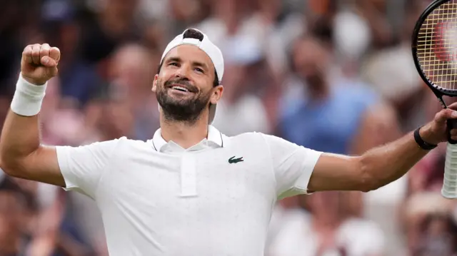 Grigor Dimitrov holds up his fist
