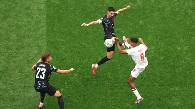 Stephen Eustaquio competes for the ball Azzedine Ounahi