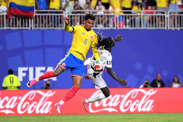Richard Rios competes for the ball against Gideon Mensah