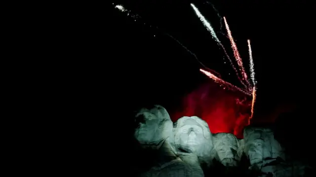 Fireworks light up the dark sky behind the four faces of the former presidents on Mount Rushmore