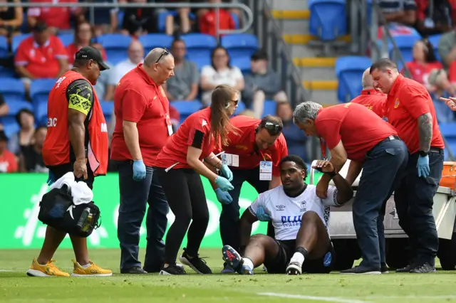 Tim Hoyt of Fiji leaves the field injured