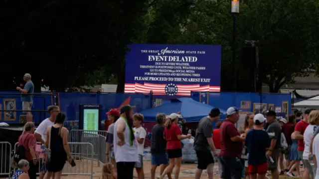 A screen displays a severe weather warning message, during the Great American State Fair on the National Mall, marking the 250th anniversary of US Independence