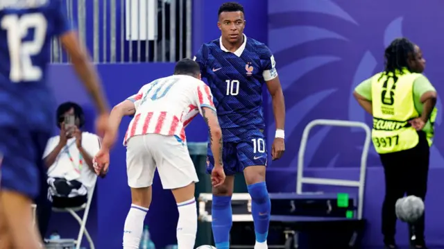 Miguel Almiron marks Kylian Mbappe