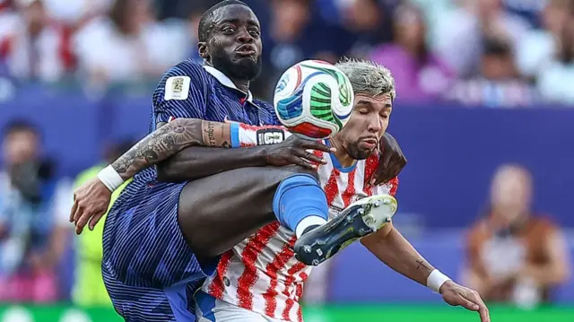 Dayot Upamecano and Julio Enciso compete for the ball