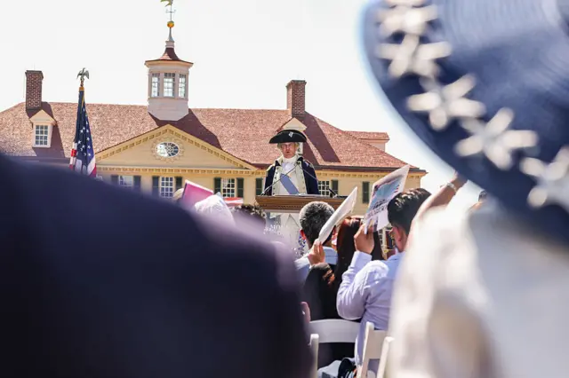 A George Washington reenactor speaks to new US citizens during a naturalization ceremony at George Washington's Mount Vernon in Mount Vernon, Virginia, US