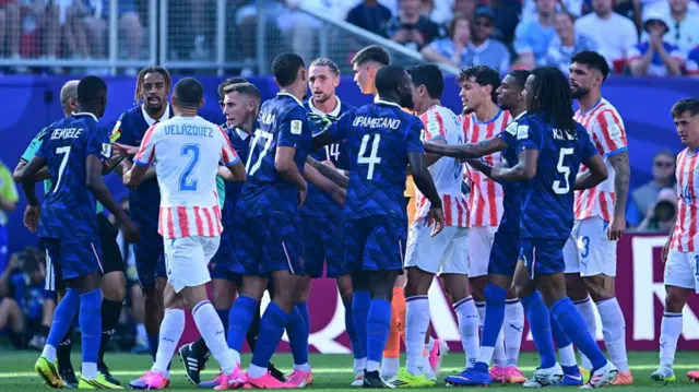 France and Paraguay players confront eachother