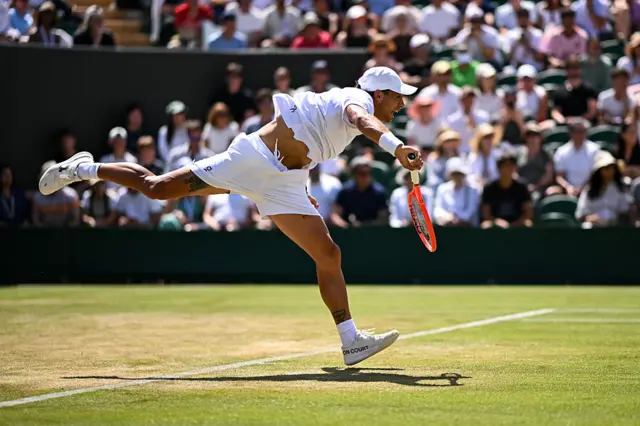 Flavio Cobolli serves