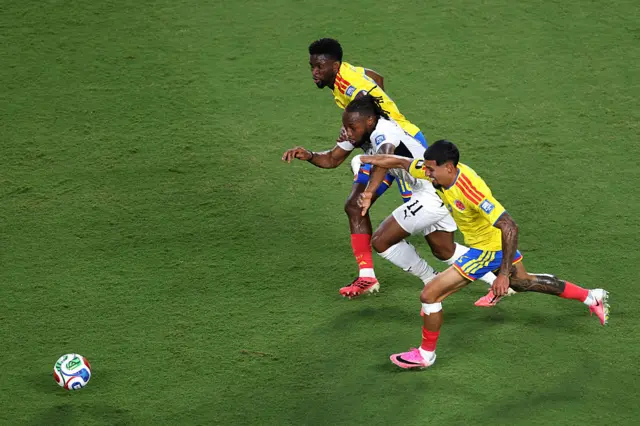 Antoine Semenyo competes for the ball against Jefferson Lerma and Daniel Munoz