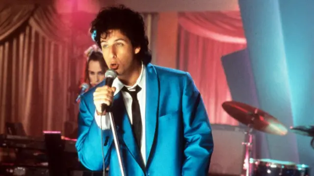 Adam Sandler wearing a blue suit in the movie The Wedding Singer