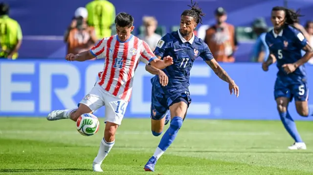 Andres Cubas and Michael Olise of France battle for the ball d