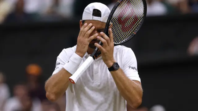 Grigor Dimitrov covers his face