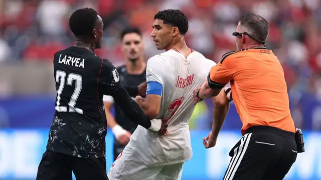 Michael Oliver intervenes as Achraf Hakimi confronts Richie Laryea