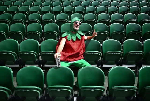 Man in strawberry outfit