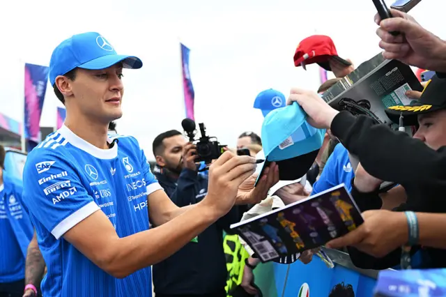 George Russell signs autographs