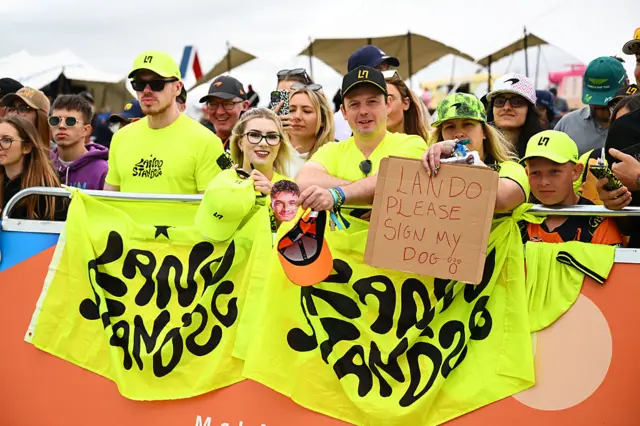 Fans hold up signs for Lando Norris
