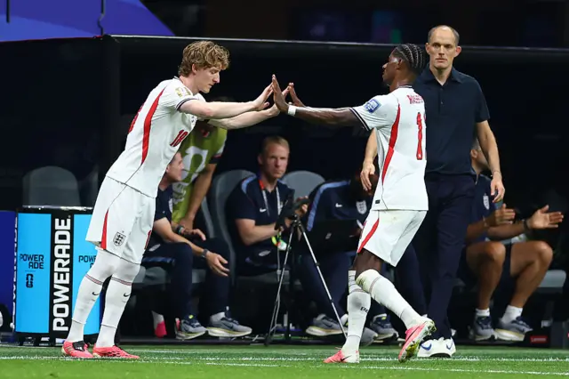 Gordon Madueke high five as they swap positions