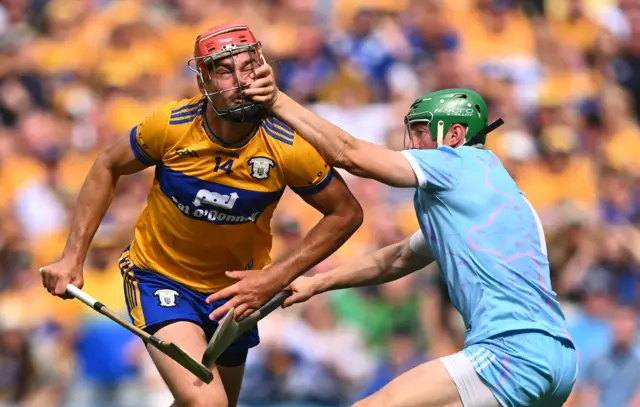 Peter Duggan of Clare is fouled by Limerick goalkeeper Nickie Quaid, before a penalty was awarded to Clare