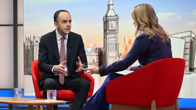 James Murray and Laura Kuenssberg during interview, sat on red chairs.